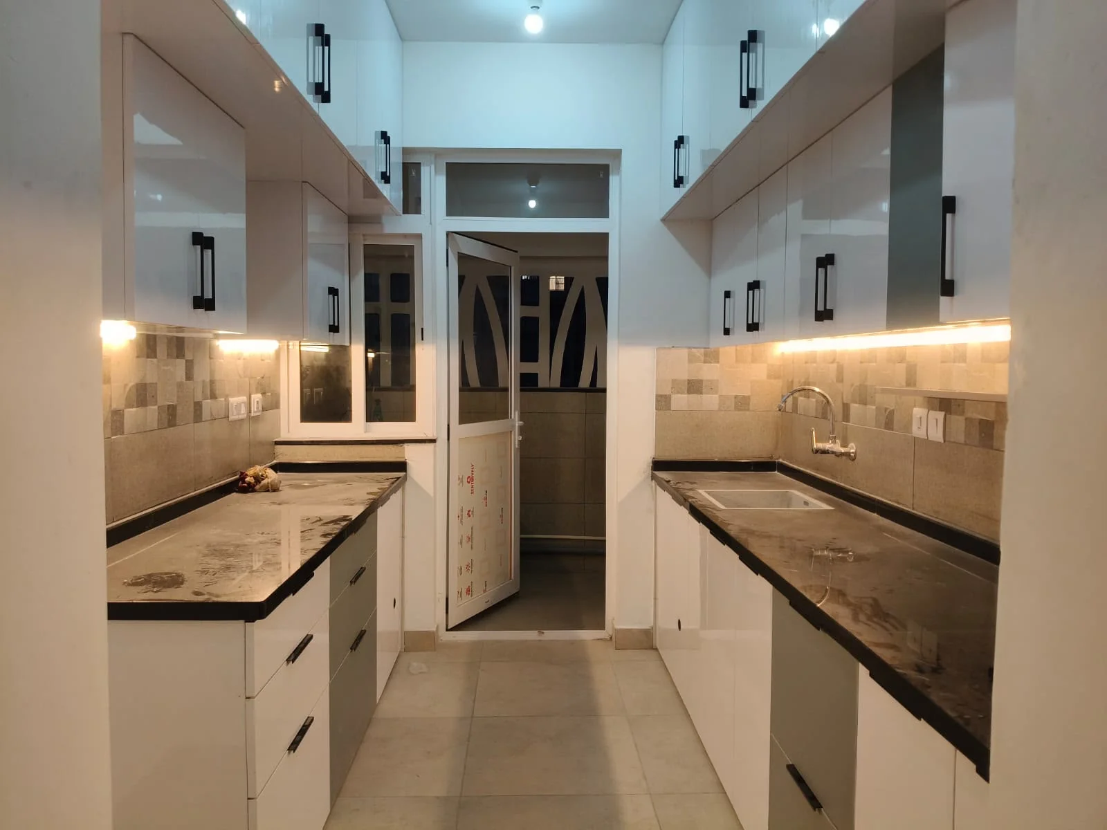 Modular kitchen with warm cabinetry and lighting